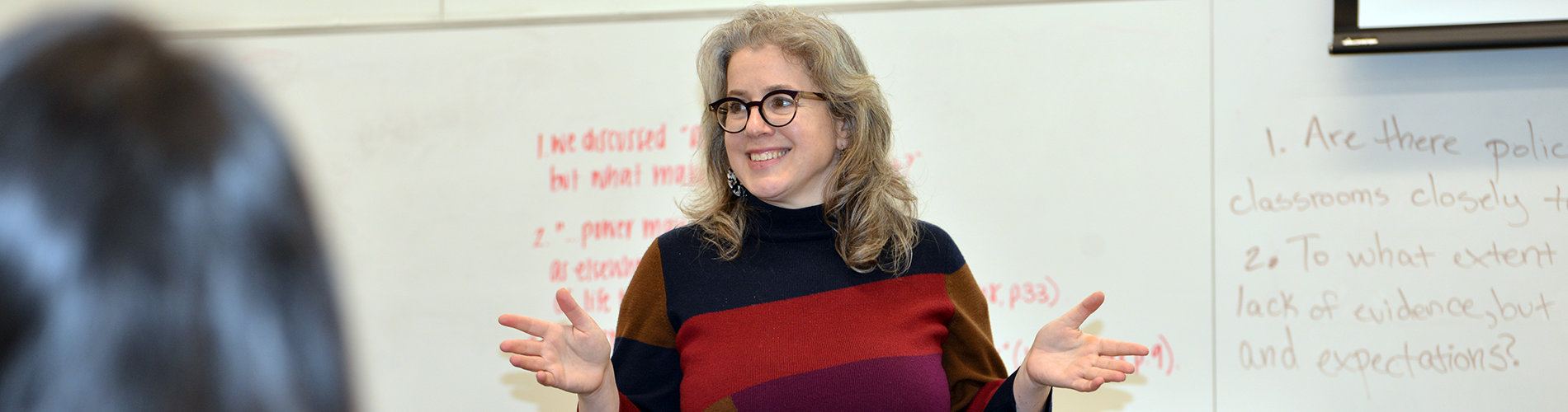 Professor Alexandra Freidus stands in a classroom and speaks.
